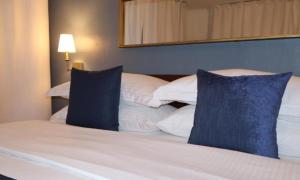 a bedroom with a bed with blue pillows at Hotel Downtown-Miami SQR in Miami