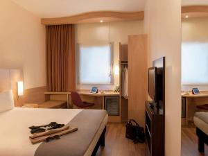 a hotel room with a bed and a television at Ibis Istanbul Esenyurt in Istanbul