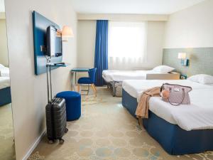 a hotel room with two beds and a tv at ibis Styles Tours Centre in Tours +167 photos