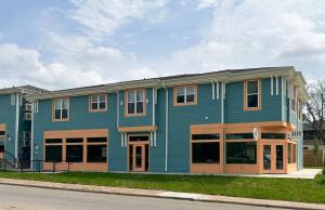 a blue building with windows on a street at Charming & Spacious Hideaway by Downtown Bryan in Bryan