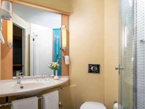 a bathroom with a sink and a toilet and a shower at ibis Adana in Adana