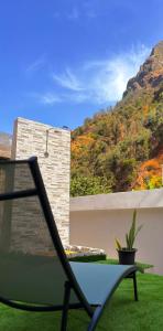 a chair on a balcony with a view of a mountain at Old Aqueduct Village 2 - Guesthouse Madeira in Serra de Água