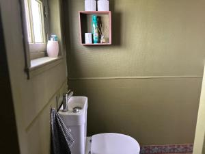 a bathroom with a toilet and a sink and a window at Maison chic et cosy in Roye