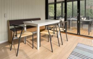 a dining room with a white table and chairs at 3 Bedroom Stunning Home In Grenaa in Grenå