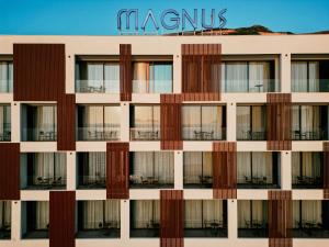 a facade of a building with a sign on it at Magnus Hotel & SPA in Vlorë