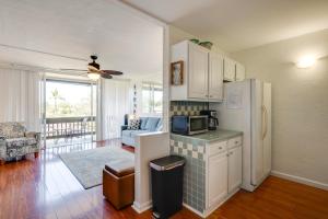 a kitchen with a refrigerator and a living room at Walk to Napili Bay Beach! Mtn-View Lahaina Condo in Kahana