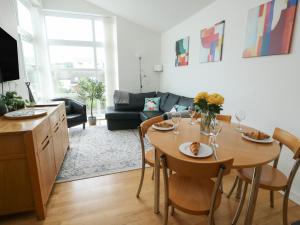 a living room with a table with chairs and a couch at Seaview in Benllech