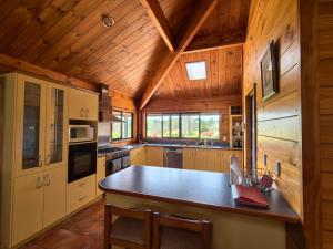 a kitchen with a table and chairs in a cabin at Beaver Farm House in Bombay