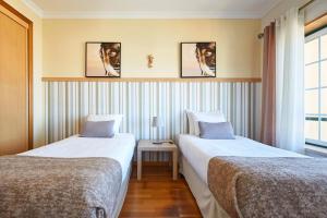 Giường trong phòng chung tại Ericeira Sunset Lifestyle I +39 ảnh