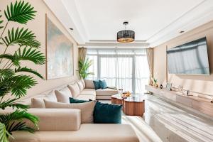 a living room with couches and a large window at Modern Luxury Oasis in Tangier