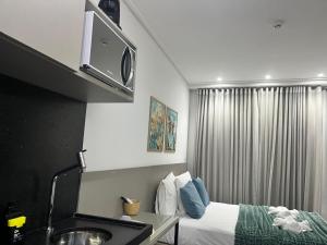 a hotel room with a bed and a sink at Flat no Move em Tambaú in João Pessoa +14 photos