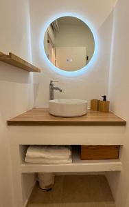 a bathroom with a sink and a mirror at Le Cloître du Palais - Studio in Avignon