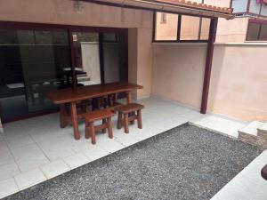 a wooden table and benches on a patio at El Hierro in Frontera