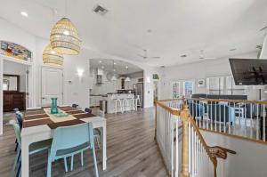 a dining room and kitchen with a table and chairs at Beach Hot Tub & Pool Getaway in Palm Coast walk or bike to the beach in Marineland