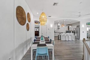 a dining room and kitchen with a table and chairs at Beach Hot Tub & Pool Getaway in Palm Coast walk or bike to the beach in Marineland +92 photos