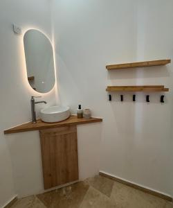 a bathroom with a sink and a mirror at À Deux Pas du Palais in Avignon +6 photos