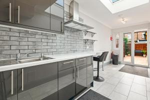 a kitchen with a sink and a counter at Imperial Inn Studios in London +7 photos