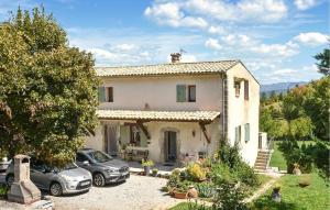 a house with two cars parked in front of it at Grande Maison in Noyers-sur-Jabron