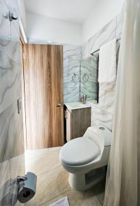 a bathroom with a toilet and a sink at Casa Eterna Campo Valdés in Medellín +81 photos