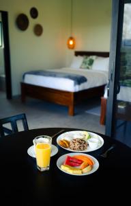 a table with two plates of food and a glass of orange juice at Cabañas Vista Verde opción sin jacuzzi in San Vito