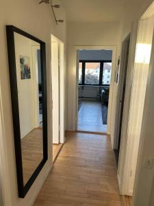 a hallway with a mirror on the wall at Bright & cozy city apartment in Hvidovre
