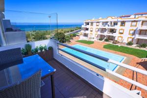 a balcony with a blue table and a view of a building at Ericeira Sunset Lifestyle II in Ericeira