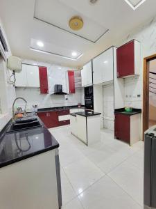 a large kitchen with red and white cabinets and appliances at Lunar in Mama +13 photos