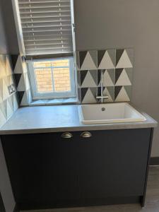 a kitchen counter with a sink and a window at 343 Luxury in Caledonian Central London in London