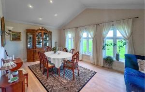 a dining room with a table and chairs at Luxurious Home In Kleppe With Wifi in Orre