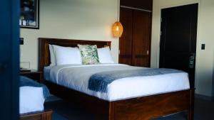a bedroom with a large bed with a wooden headboard at Cabañas Vista Verde opción con jacuzzi in San Vito