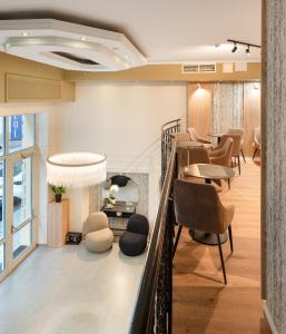 a waiting room with a table and chairs at CHLOE Hotel Budapest in Budapest