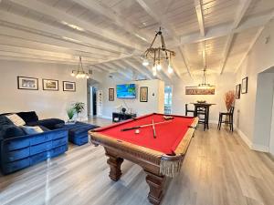 a living room with a pool table in it at Great location Pool home w Pool table 5br in Fort Lauderdale