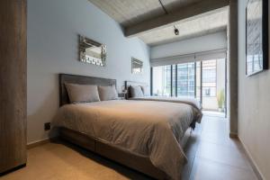 a bedroom with a large bed and a large window at Zielo 2bdrm 2 bath Private balcony, Rooftop Walk to Zocalo in Mexico City