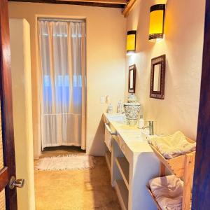 a bathroom with two sinks and a shower at Palapa Ganesh in Sayulita