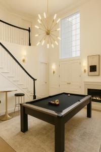 a pool table in a living room with a chandelier at Stylish Santa Monica House - Top Location in Los Angeles +2 photos