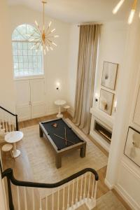 a living room with a pool table and a chandelier at Stylish Santa Monica House - Top Location in Los Angeles