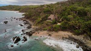 an aerial view of a house on an island in the ocean at Palapa Ganesh in Sayulita