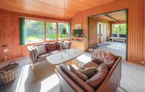 a living room with a couch and a table at Stunning Home In Tarm With Sauna in Højsand