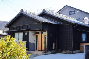 a black and white house with at Potsupotsuan - Vacation STAY 20035 in Ise