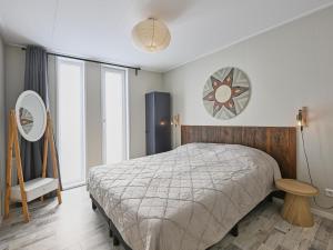 a bedroom with a bed and a large window at Casa Familia in Sint Annaland