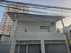 a building with a balcony in front of a tall building at COP 30 Apartamento próximo do Hangar in Belém