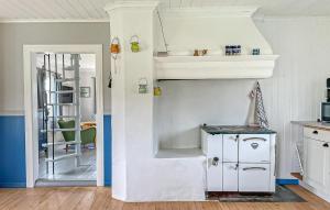 a white kitchen with a staircase in a room at 2 Bedroom Awesome Home In Töcksfors in Navarsviken