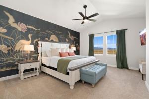 a bedroom with a bed with a large painting on the wall at Scenic Mountain Retreat Golf, Pickleball, Relax in Loveland +24 photos