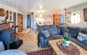 a living room with a blue couch and a table at 3 Bedroom Gorgeous Home In Farsund in Farsund
