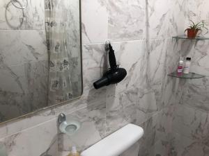 a bathroom with a shower with a mirror and a sink at Refugio Urbano 2 in Corrientes