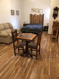 a living room with a table and a bed at Refugio Urbano 2 in Corrientes