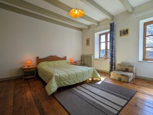a bedroom with a bed and two windows at Gîte restauré avec grand terrain clos, salle de jeux, proche du Puy en Velay et Chavaniac-Lafayette - FR-1-582-297 in Jax