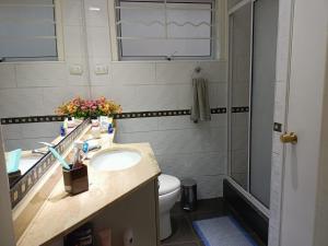 a bathroom with a sink and a toilet at Casa en Viña del Mar in Viña del Mar