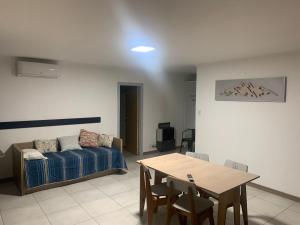 a living room with a couch and a table at Departamento Acrux in Malargüe