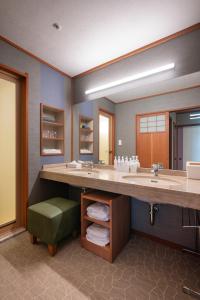 a bathroom with a large sink and a large mirror at Kashikojima Hojoen in Shima